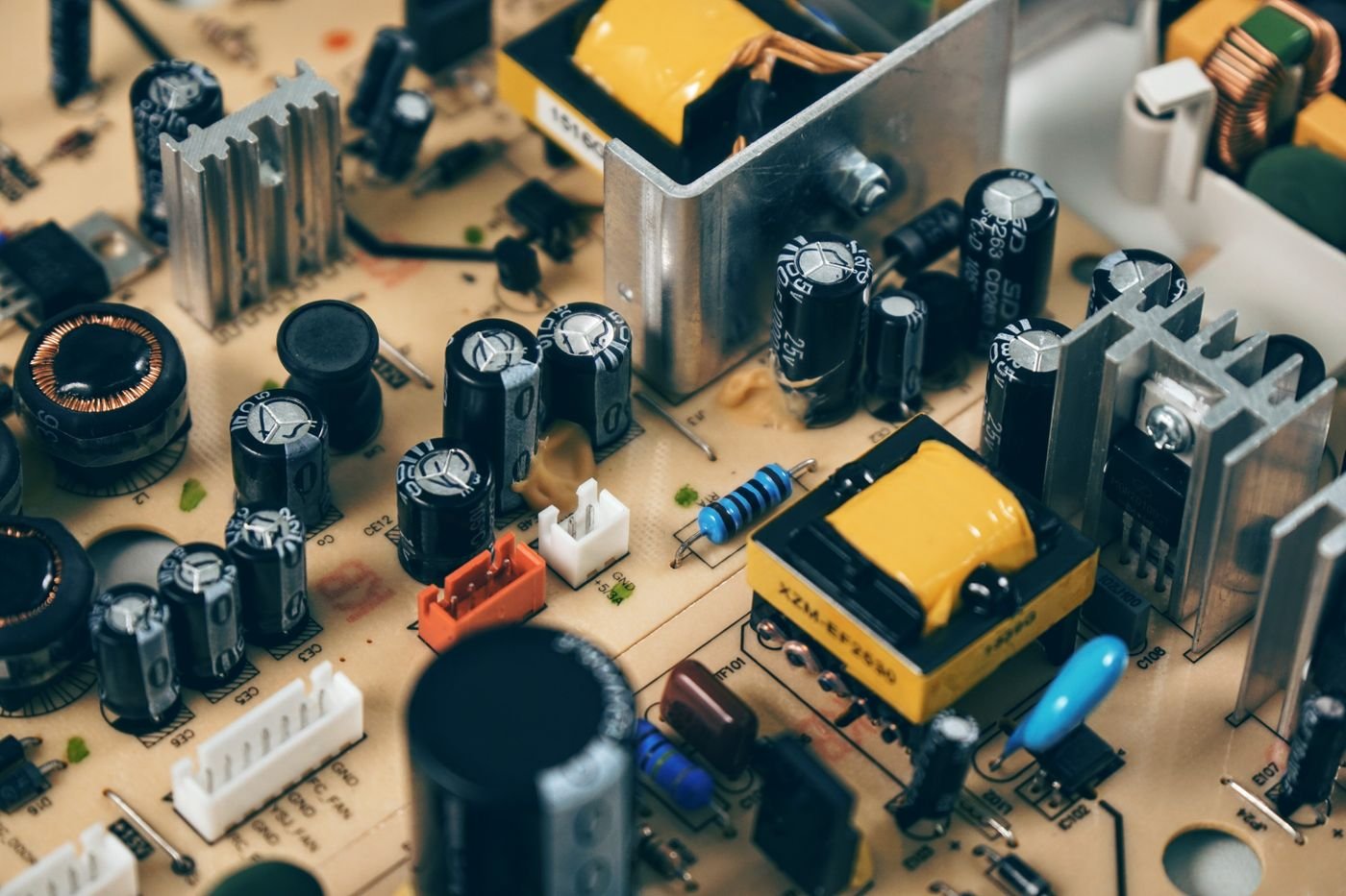 Close view of capacitors, connectors and resistors on a circuit assembly